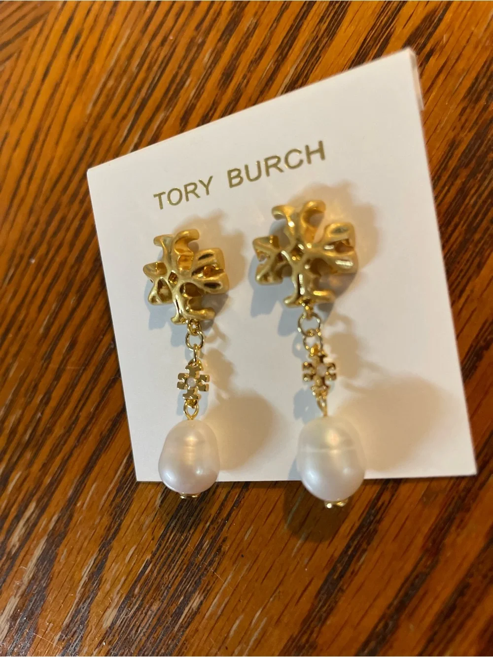 Brand new pearl-drop earrings by Tory Burch.